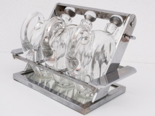 Jacques Adnet attributed tantulus containing three Baccarat Carafes