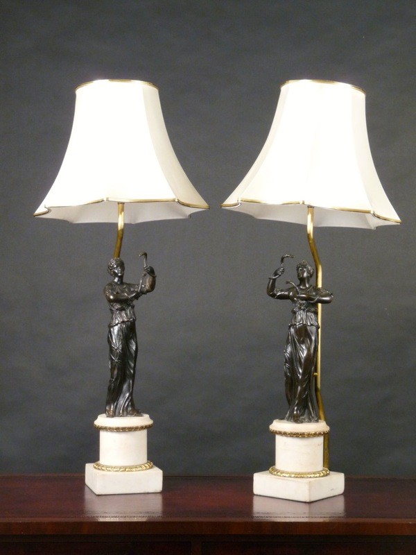A pair of bronze figural table lamps